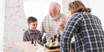 son playing chess dad