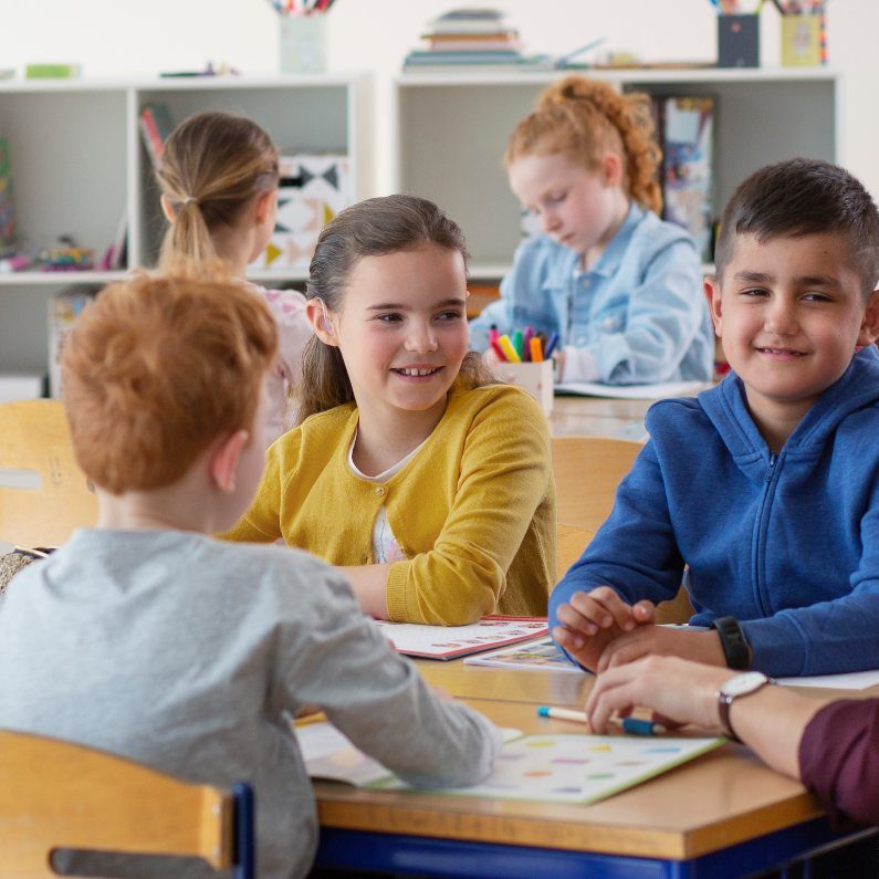 Teenagers at school with hearing aids