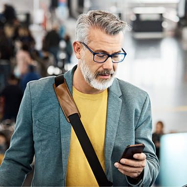 a man with a hearing aid is talking on the phone